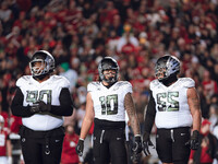 Oregon defensive lineman Jamaree Caldwell #90, Oregon outside linebacker Matayo Uiagalelei #10, and Oregon defensive lineman Derrick Harmon...