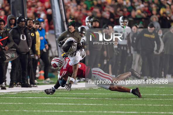 Oregon wide receiver Gary Bryant Jr. #2 is up-ended by Wisconsin Badgers cornerback Nyzier Fourqurean #3 at Camp Randall Stadium in Madison,...