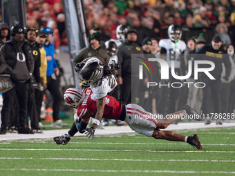 Oregon wide receiver Gary Bryant Jr. #2 is up-ended by Wisconsin Badgers cornerback Nyzier Fourqurean #3 at Camp Randall Stadium in Madison,...