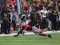 Oregon wide receiver Gary Bryant Jr. #2 is up-ended by Wisconsin Badgers cornerback Nyzier Fourqurean #3 at Camp Randall Stadium in Madison,...