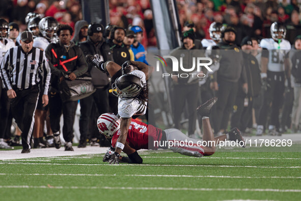 Oregon wide receiver Gary Bryant Jr. #2 is up-ended by Wisconsin Badgers cornerback Nyzier Fourqurean #3 at Camp Randall Stadium in Madison,...