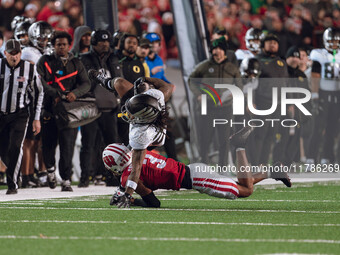 Oregon wide receiver Gary Bryant Jr. #2 is up-ended by Wisconsin Badgers cornerback Nyzier Fourqurean #3 at Camp Randall Stadium in Madison,...