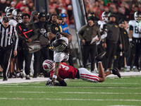 Oregon wide receiver Gary Bryant Jr. #2 is up-ended by Wisconsin Badgers cornerback Nyzier Fourqurean #3 at Camp Randall Stadium in Madison,...