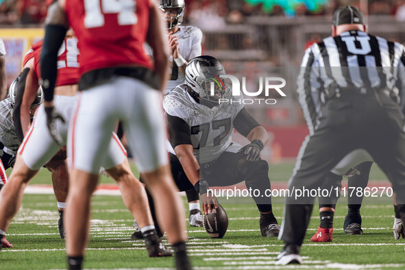 Oregon offensive lineman Matthew Bedford #77 communicates before the snap against the Wisconsin Badgers at Camp Randall Stadium in Madison,...