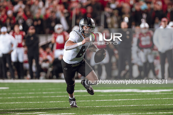 Oregon quarterback Dillon Gabriel #8 scrambles against the Wisconsin Badgers at Camp Randall Stadium in Madison, Wisconsin, on November 16,...