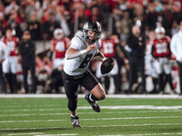 Oregon quarterback Dillon Gabriel #8 scrambles against the Wisconsin Badgers at Camp Randall Stadium in Madison, Wisconsin, on November 16,...