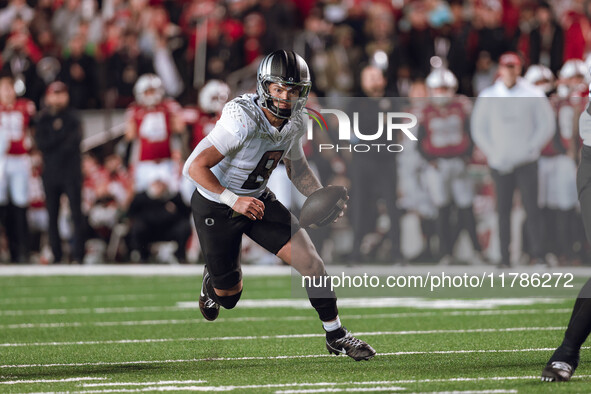 Oregon quarterback Dillon Gabriel #8 scrambles against the Wisconsin Badgers at Camp Randall Stadium in Madison, Wisconsin, on November 16,...