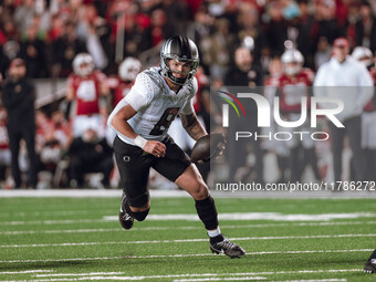 Oregon quarterback Dillon Gabriel #8 scrambles against the Wisconsin Badgers at Camp Randall Stadium in Madison, Wisconsin, on November 16,...