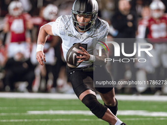 Oregon quarterback Dillon Gabriel #8 scrambles against the Wisconsin Badgers at Camp Randall Stadium in Madison, Wisconsin, on November 16,...