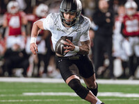 Oregon quarterback Dillon Gabriel #8 scrambles against the Wisconsin Badgers at Camp Randall Stadium in Madison, Wisconsin, on November 16,...