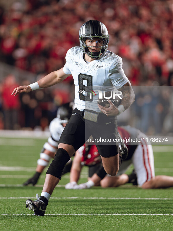 Oregon quarterback Dillon Gabriel #8 scrambles against the Wisconsin Badgers at Camp Randall Stadium in Madison, Wisconsin, on November 16,...