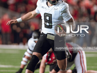 Oregon quarterback Dillon Gabriel #8 scrambles against the Wisconsin Badgers at Camp Randall Stadium in Madison, Wisconsin, on November 16,...