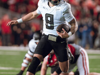 Oregon quarterback Dillon Gabriel #8 scrambles against the Wisconsin Badgers at Camp Randall Stadium in Madison, Wisconsin, on November 16,...