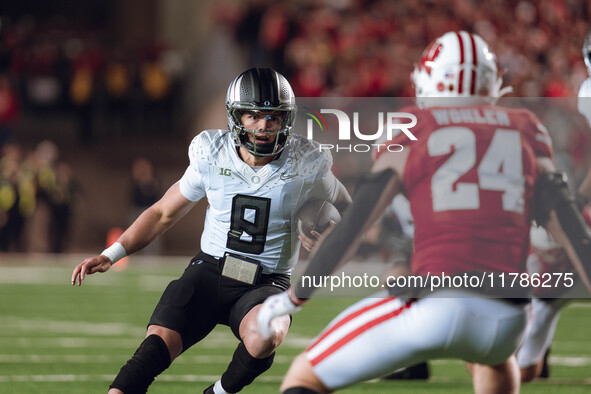 Oregon quarterback Dillon Gabriel #8 scrambles against the Wisconsin Badgers at Camp Randall Stadium in Madison, Wisconsin, on November 16,...