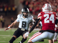 Oregon quarterback Dillon Gabriel #8 scrambles against the Wisconsin Badgers at Camp Randall Stadium in Madison, Wisconsin, on November 16,...