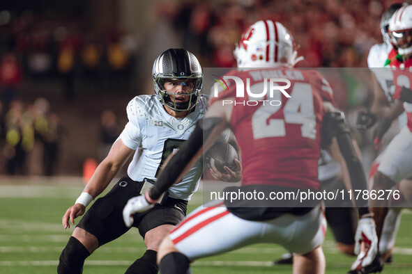 Oregon quarterback Dillon Gabriel #8 scrambles against the Wisconsin Badgers at Camp Randall Stadium in Madison, Wisconsin, on November 16,...