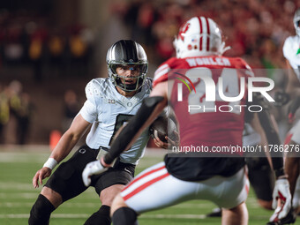 Oregon quarterback Dillon Gabriel #8 scrambles against the Wisconsin Badgers at Camp Randall Stadium in Madison, Wisconsin, on November 16,...