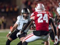 Oregon quarterback Dillon Gabriel #8 scrambles against the Wisconsin Badgers at Camp Randall Stadium in Madison, Wisconsin, on November 16,...