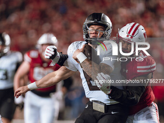 Oregon quarterback Dillon Gabriel #8 is tackled by Wisconsin Badgers defensive lineman Curt Neal #92 at Camp Randall Stadium in Madison, Wis...