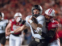 Oregon quarterback Dillon Gabriel #8 is tackled by Wisconsin Badgers defensive lineman Curt Neal #92 at Camp Randall Stadium in Madison, Wis...