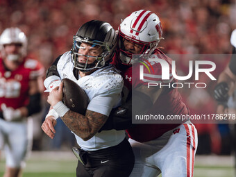 Oregon quarterback Dillon Gabriel #8 is tackled by Wisconsin Badgers defensive lineman Curt Neal #92 at Camp Randall Stadium in Madison, Wis...