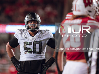 Oregon offensive lineman Nishad Strother #50 looks up at the clock in the 4th quarter against the Wisconsin Badgers at Camp Randall Stadium...