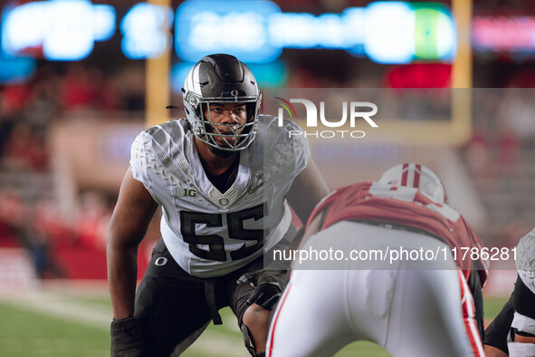 Oregon offensive lineman Marcus Harper II #55 looks at the Wisconsin Badgers defense before the snap at Camp Randall Stadium in Madison, Wis...