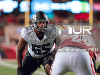 Oregon offensive lineman Marcus Harper II #55 looks at the Wisconsin Badgers defense before the snap at Camp Randall Stadium in Madison, Wis...