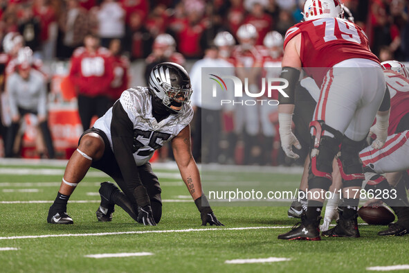 Oregon defensive lineman Derrick Harmon #55 stands in a stance before the snap against the Wisconsin Badgers at Camp Randall Stadium in Madi...