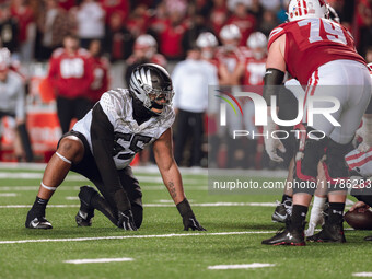 Oregon defensive lineman Derrick Harmon #55 stands in a stance before the snap against the Wisconsin Badgers at Camp Randall Stadium in Madi...