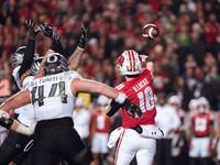 Wisconsin Badgers quarterback Braedyn Locke #18 attempts a pass against the Oregon Ducks at Camp Randall Stadium in Madison, Wisconsin, on N...