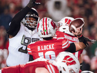 Wisconsin Badgers quarterback Braedyn Locke #18 attempts a pass against the Oregon Ducks at Camp Randall Stadium in Madison, Wisconsin, on N...