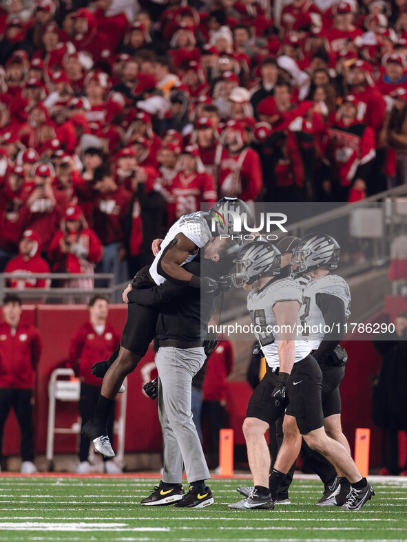 Oregon head coach Dan Lanning celebrates with his team as the Oregon Ducks seal the game with an interception late in the 4th quarter agains...