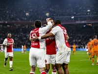 AFC Ajax Amsterdam legend players Shota Arveladze, Ricardo van Rhijn, and Ryan Babel celebrate a goal during the match between Ajax Legends...