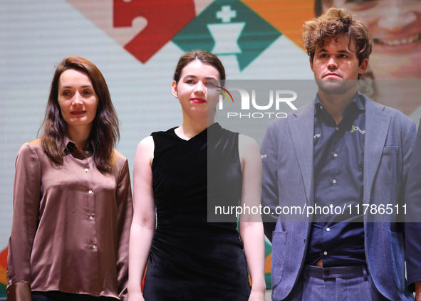 The Open Rapid and Blitz Chess winner Magnus Carlsen (R), women's blitz winner Kateryna Lagno (L), and women's rapid champion Aleksandra Gor...