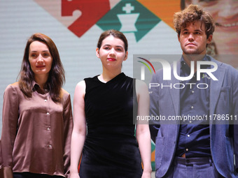 The Open Rapid and Blitz Chess winner Magnus Carlsen (R), women's blitz winner Kateryna Lagno (L), and women's rapid champion Aleksandra Gor...