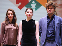 The Open Rapid and Blitz Chess winner Magnus Carlsen (R), women's blitz winner Kateryna Lagno (L), and women's rapid champion Aleksandra Gor...