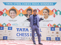 Norway's Magnus Carlsen poses for a picture with his trophies after winning the Open Rapid and Blitz Chess at the Tata Steel Chess India Tou...