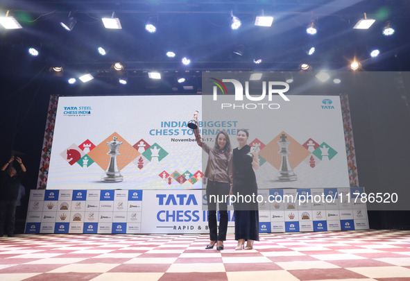 Women's blitz winner, Russian Kateryna Lagno, and women's rapid champion, Russian Aleksandra Goryachkina, pose for a picture with their trop...