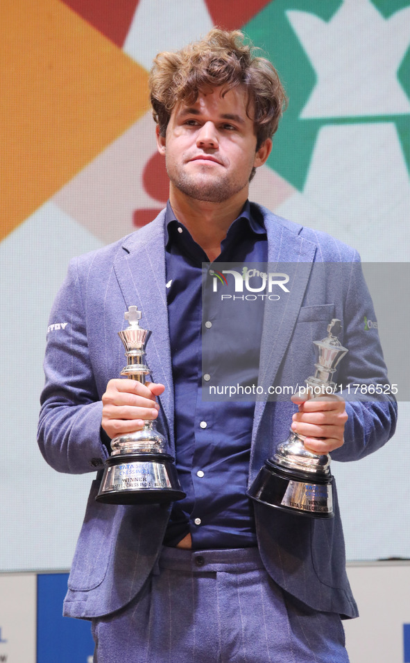 Norway's Magnus Carlsen poses for a picture with his trophies after winning the Open Rapid and Blitz Chess at the Tata Steel Chess India Tou...