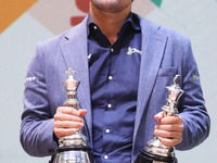 Norway's Magnus Carlsen poses for a picture with his trophies after winning the Open Rapid and Blitz Chess at the Tata Steel Chess India Tou...