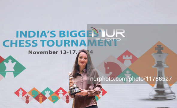 Woman blitz winner Russian Kateryna Lagno poses for a picture with her trophies at the Tata Steel Chess India Tournament in Kolkata, India,...