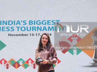 Woman blitz winner Russian Kateryna Lagno poses for a picture with her trophies at the Tata Steel Chess India Tournament in Kolkata, India,...