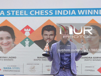 Norway's Magnus Carlsen poses for a picture with his trophies after winning the Open Rapid and Blitz Chess at the Tata Steel Chess India Tou...