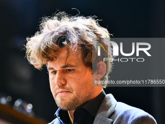 Norwegian GM Magnus Carlsen plays chess during the 6th TATA Steel Chess India Tournament at Dhono Dhanyo Auditorium in Kolkata, India, on No...