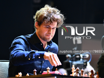 Norwegian GM Magnus Carlsen plays chess during the 6th TATA Steel Chess India Tournament at Dhono Dhanyo Auditorium in Kolkata, India, on No...