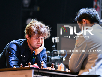 Norway's GM Magnus Carlsen plays Blitz round chess against Indian GM Arjun Erigaisi during the 6th TATA Steel Chess India Tournament at Dhon...