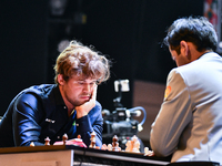 Norway's GM Magnus Carlsen plays Blitz round chess against Indian GM Arjun Erigaisi during the 6th TATA Steel Chess India Tournament at Dhon...