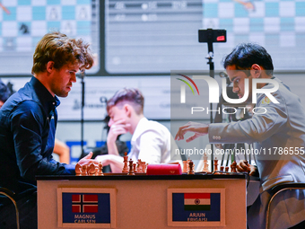 Norway's GM Magnus Carlsen plays Blitz round chess against Indian GM Arjun Erigaisi during the 6th TATA Steel Chess India Tournament at Dhon...