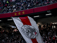 Fans of Ajax hold a flag with the old logo of Ajax during the match between Ajax Legends and Real Madrid Legends at the Johan Cruijff ArenA...